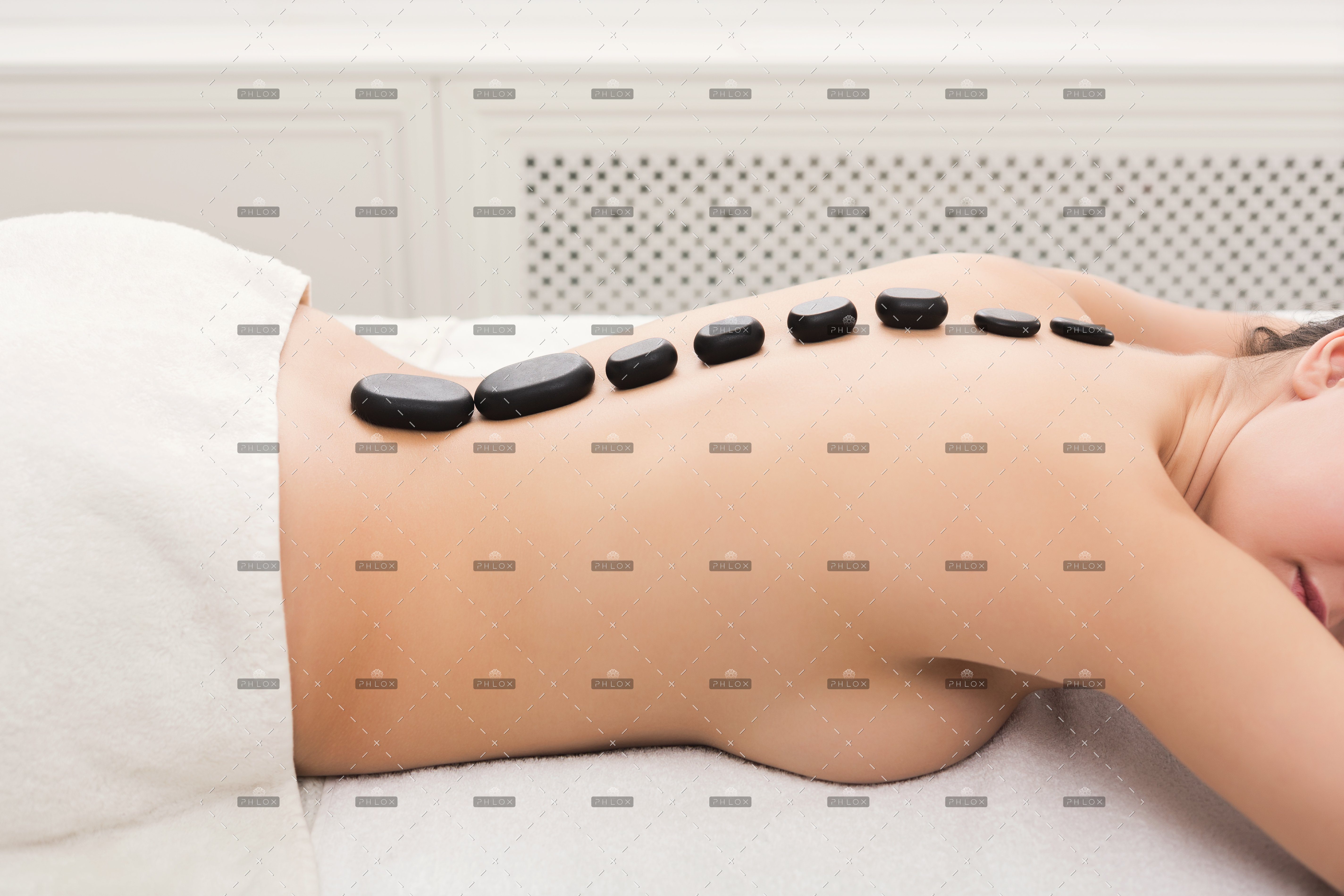 demo-attachment-113-woman-getting-hot-stones-massage-at-spa-salon-5AVNW2T